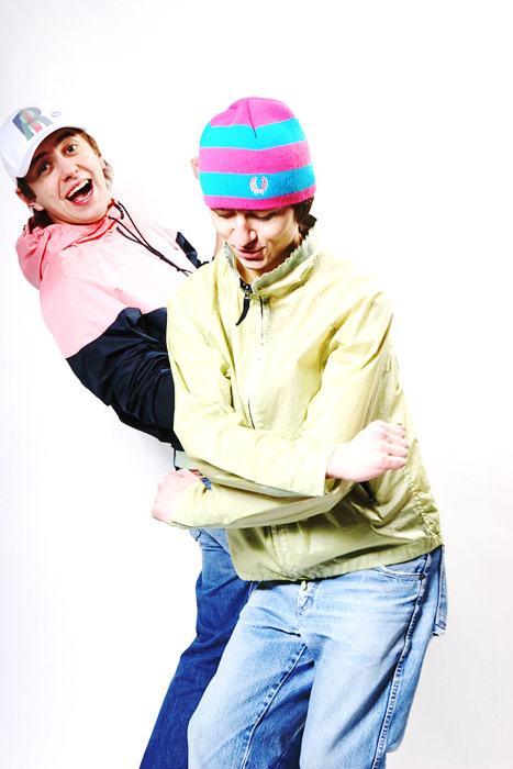two boys one wearing a hat and the other blue in a silly pose