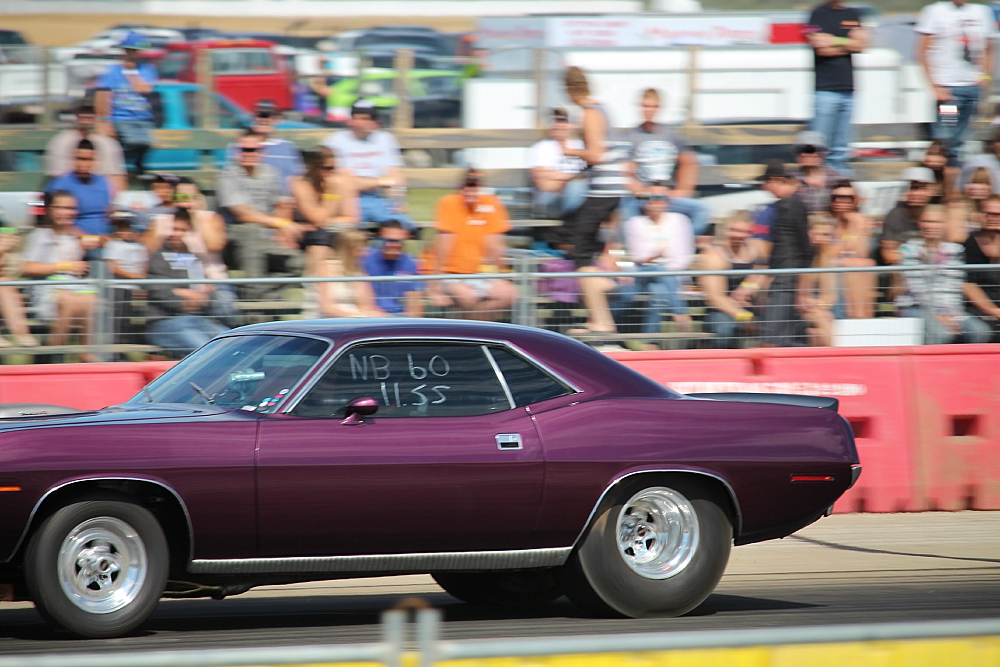 a purple car is driving around on the street