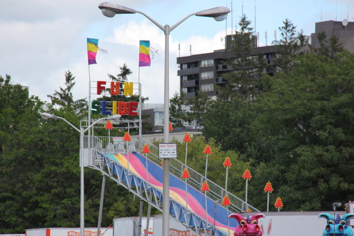 several colored flags line a street with several traffic lights and traffic signs