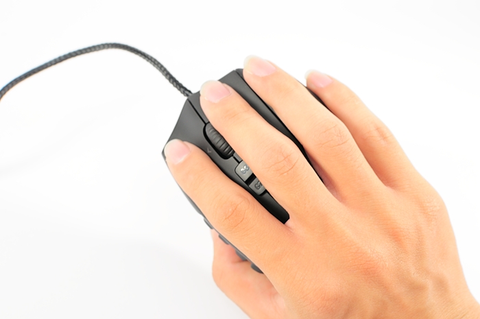 a person's hand holding a black computer mouse