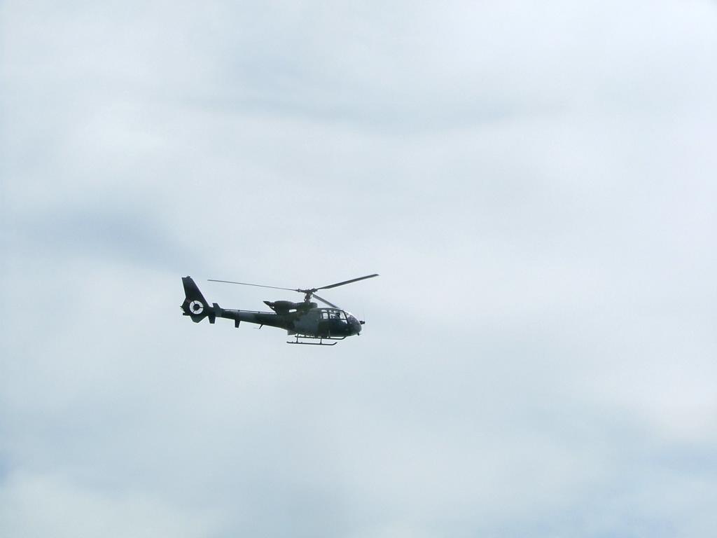 two army helicopter flying side by side against the sky