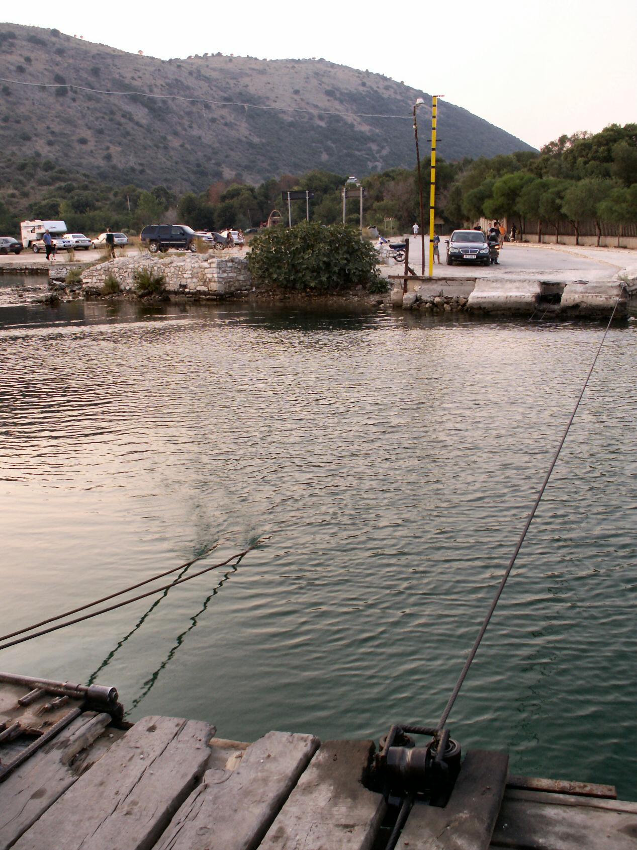 a boat tied up to a dock on a river