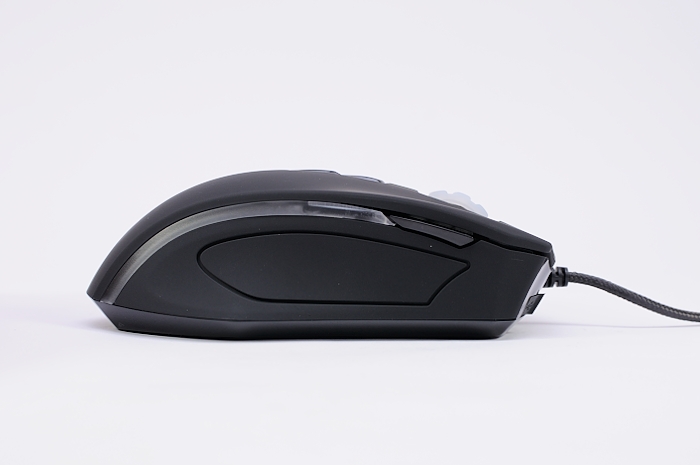 a black wireless mouse is on a white surface