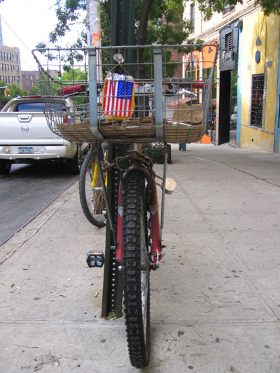 a bike is shown tied to a pole with a basket