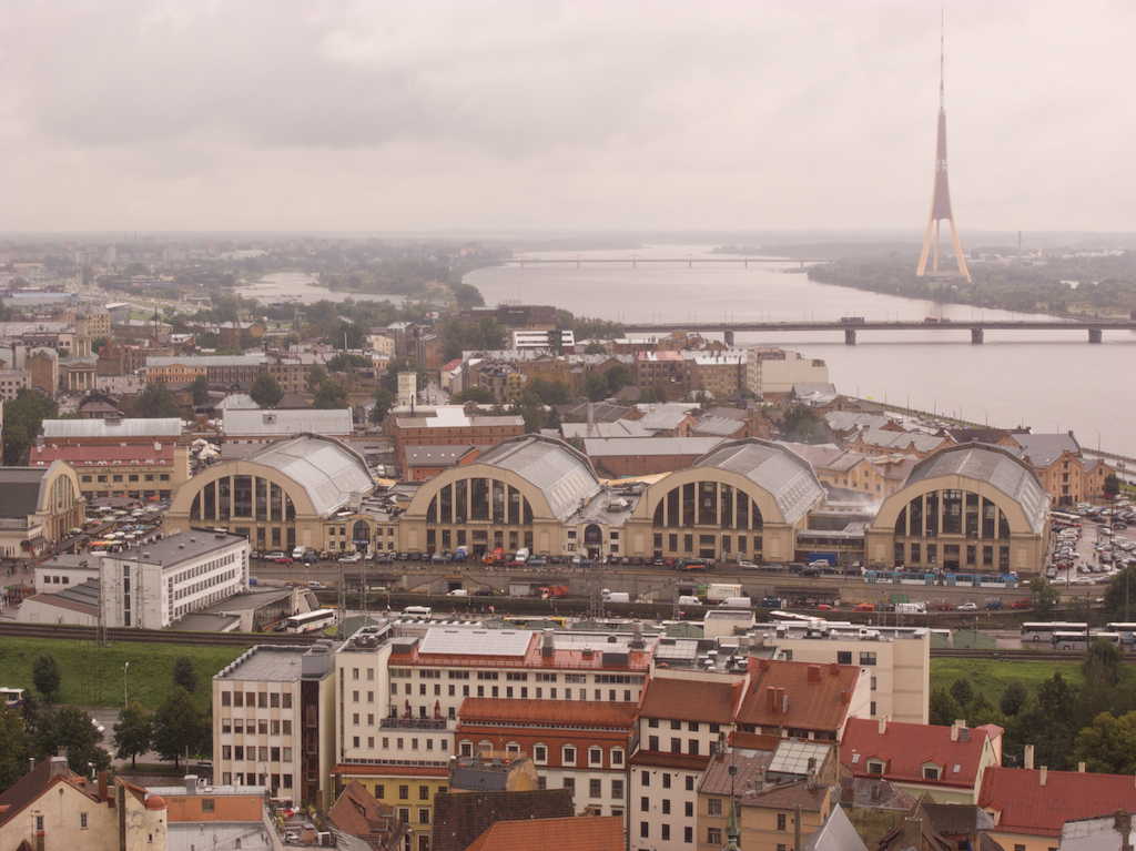 an aerial view of the city with a bridge in the background