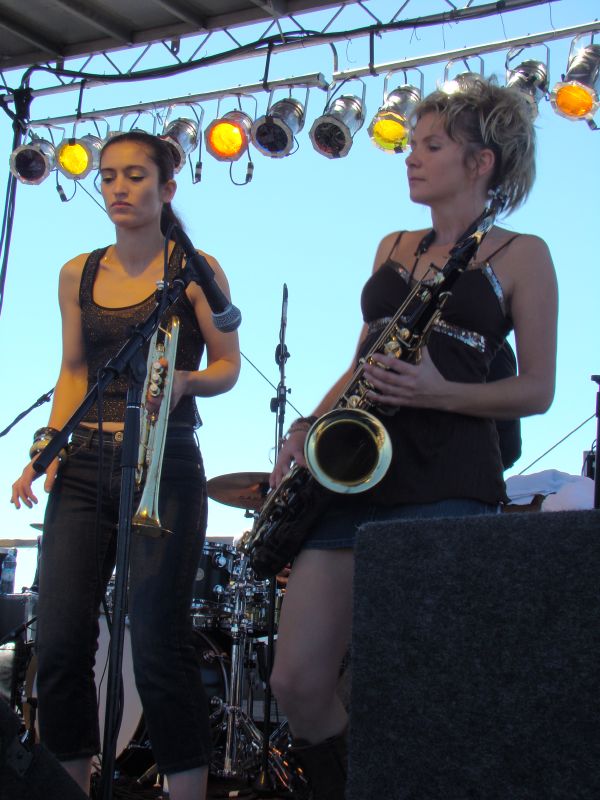 three women on stage with their instruments