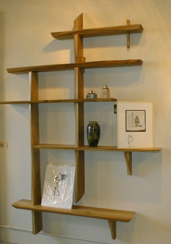 a modern art display of wooden shelves with items on top
