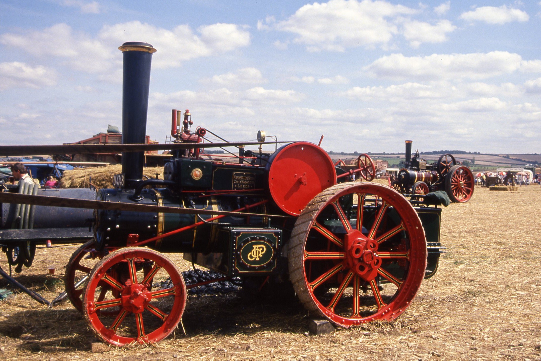 an old fashioned fire engine parked in the grass