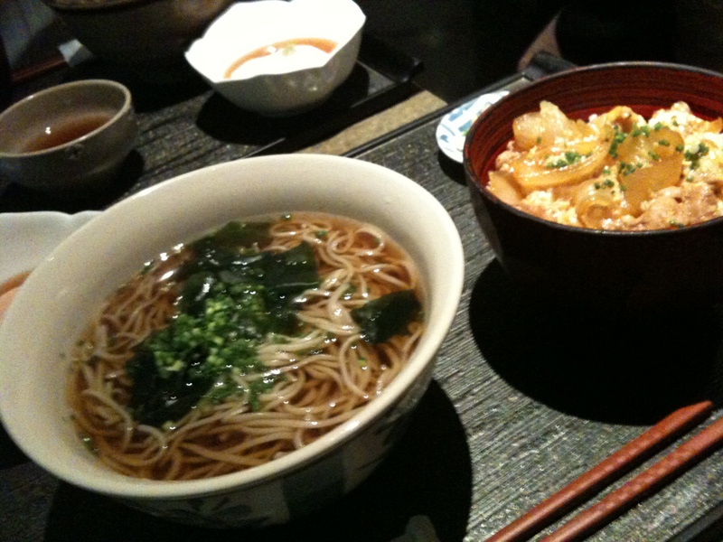 a table topped with bowls and a bowl of noodles