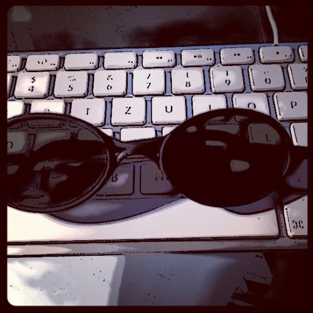 a pair of sunglasses sitting on top of a keyboard