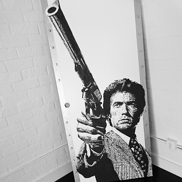 a person with a gun painted on a sign