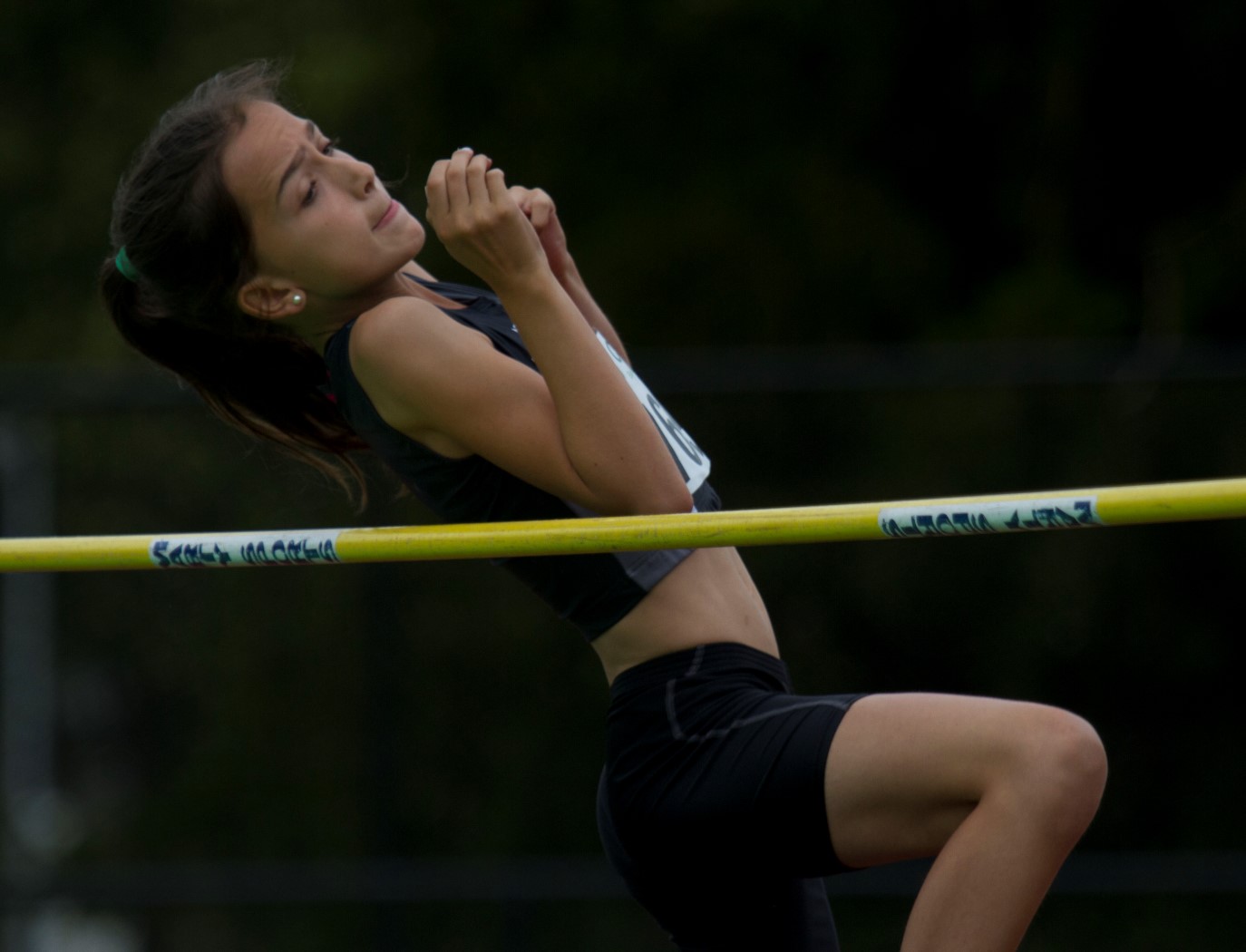 a woman in midair during a high jump