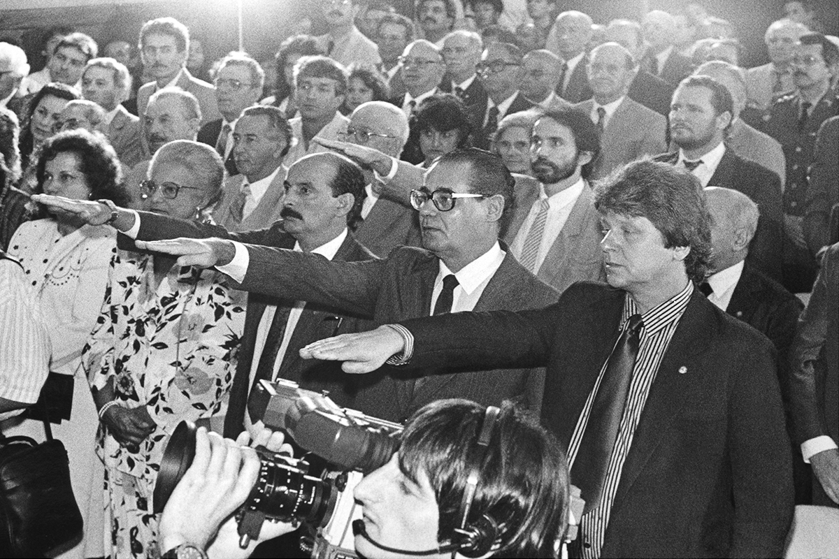 an old po of two people in a crowd with microphones and others