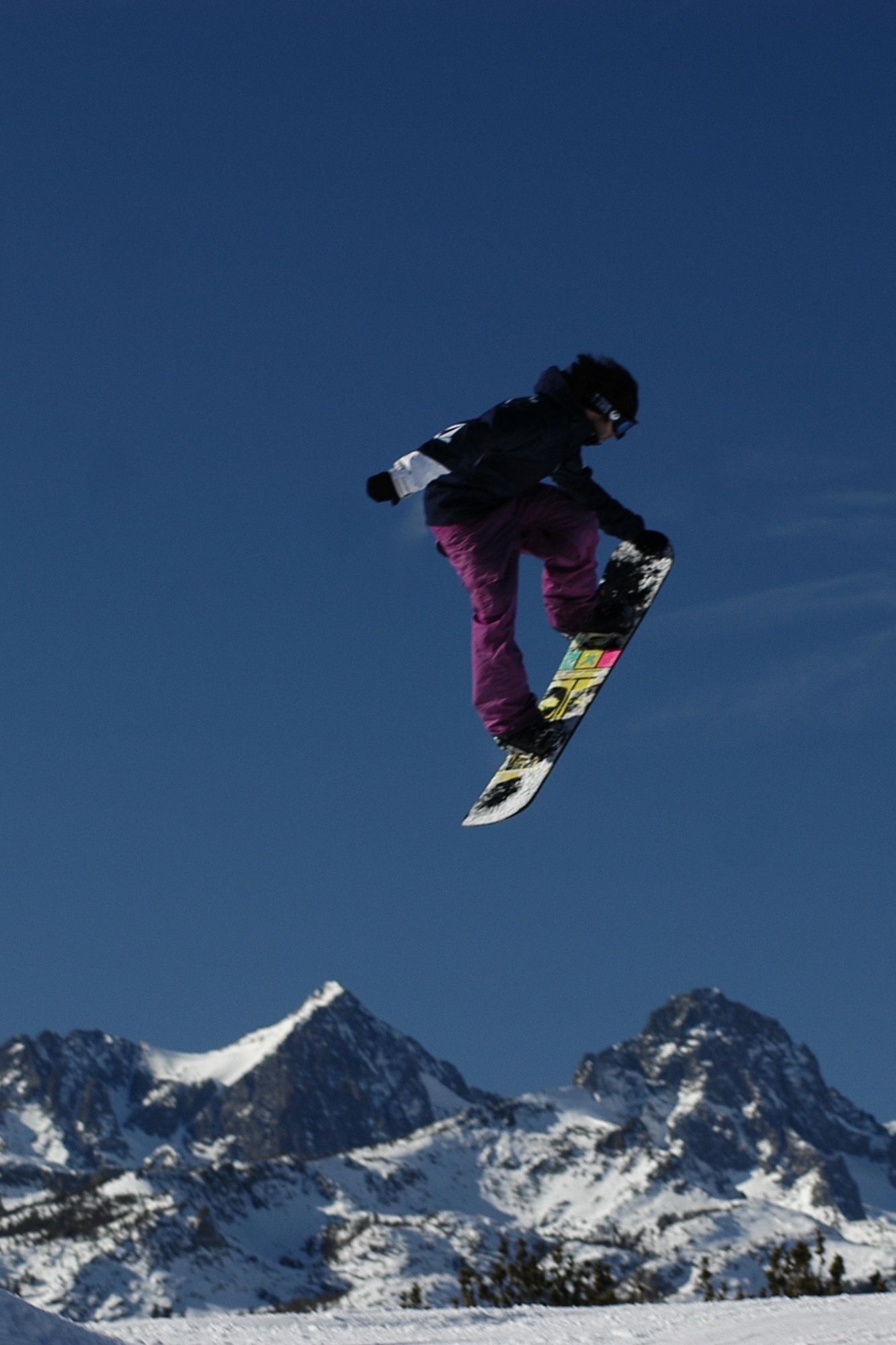 a man is doing a snowboard trick in the air