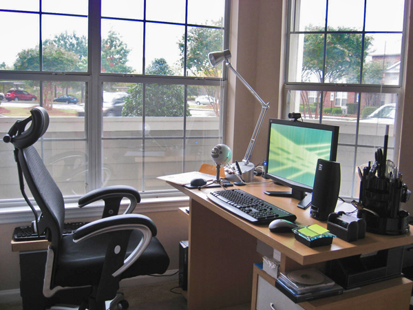 a chair in front of the desk with a computer