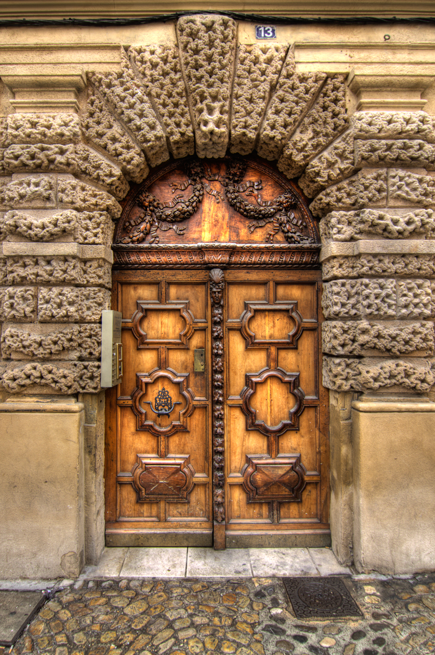 wooden door to a building with arched glass