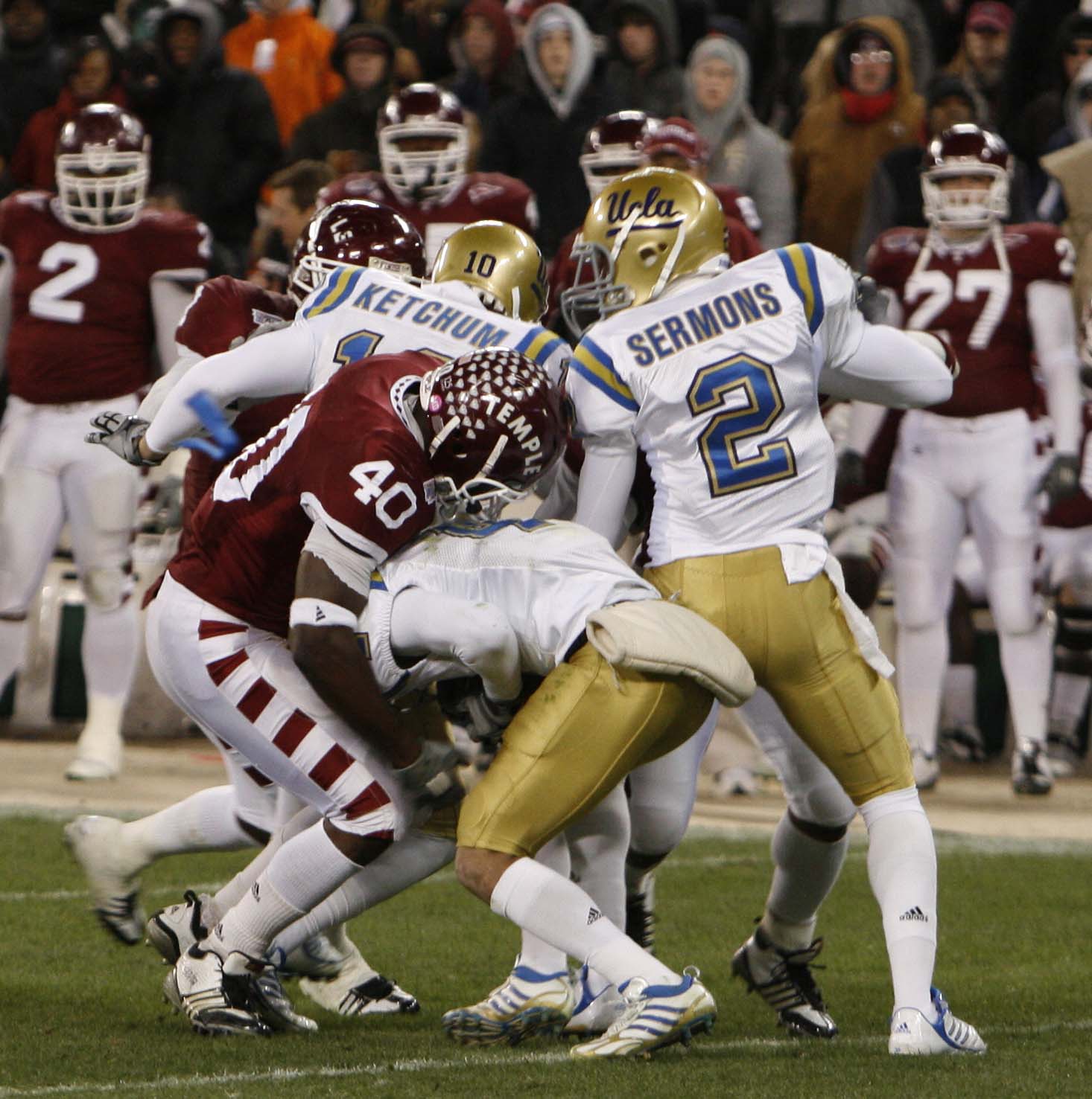 a football game showing several players, two with opposing teams