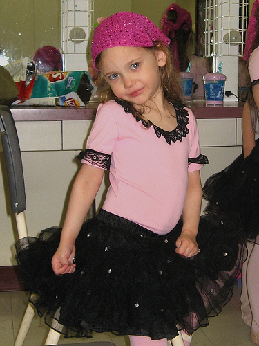 a small girl poses in her party outfit