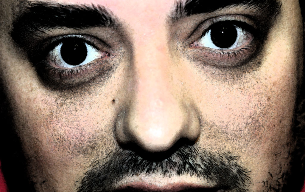 a closeup of a man's face with a beard and beard