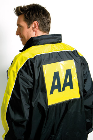 a man wearing an ae jacket standing next to a white wall