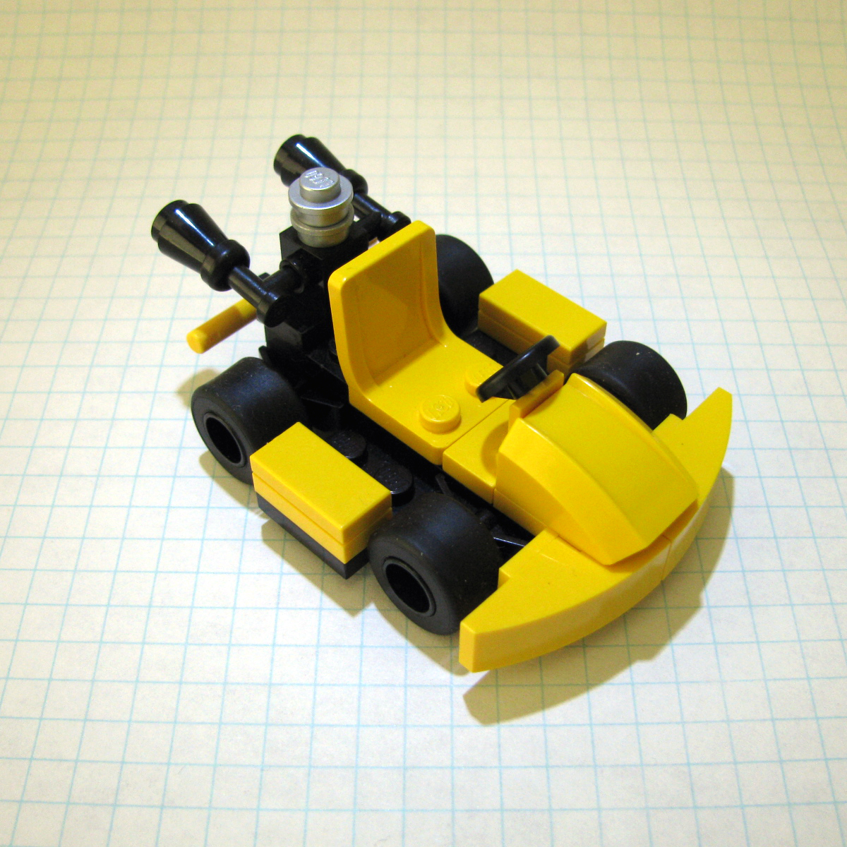 a yellow vehicle that is designed out of legos