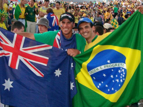 two men holding flags in a crowd