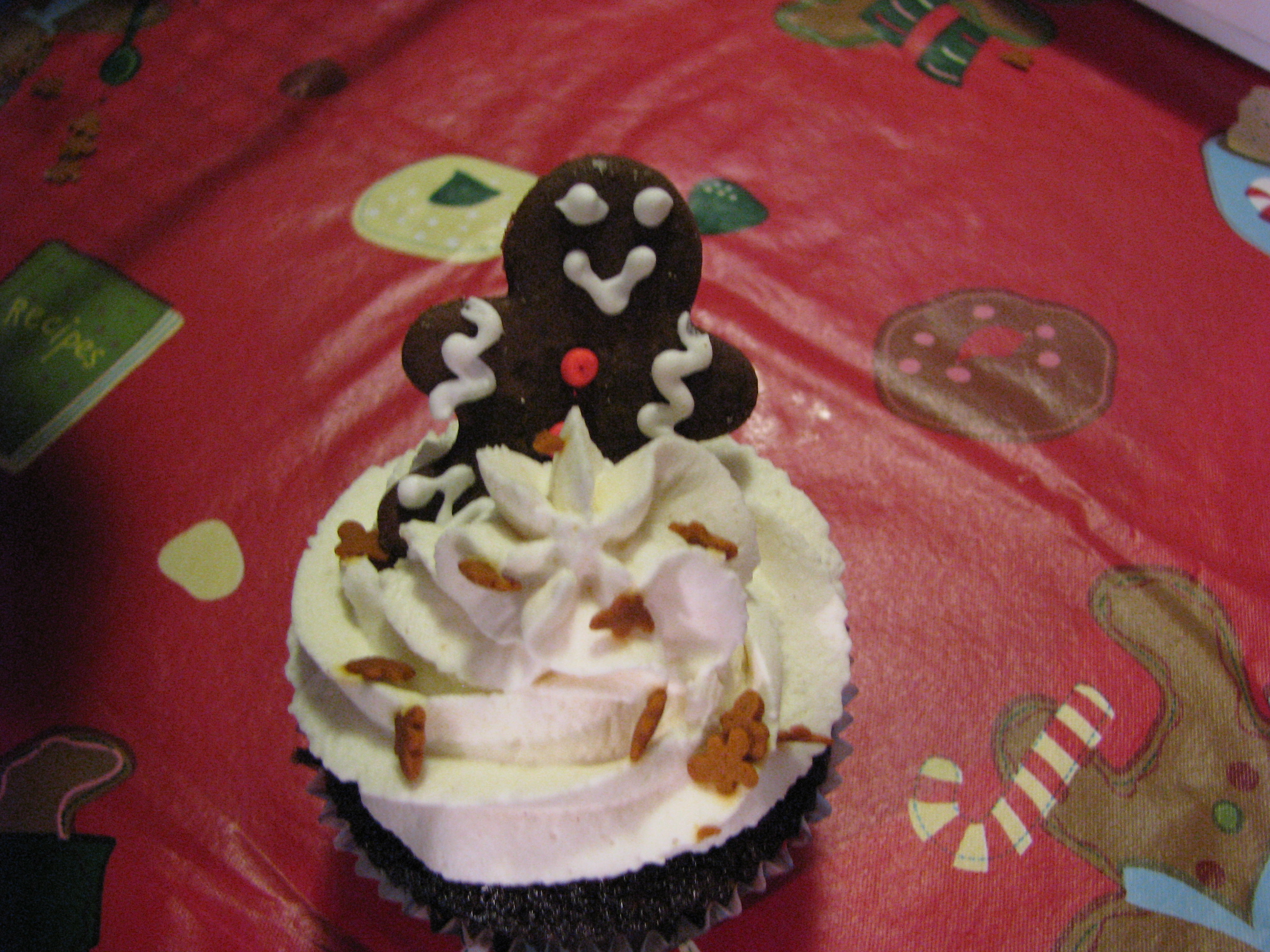 cupcakes are decorated with icing and ginger bears