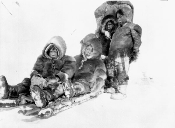 some people sitting next to each other on snow
