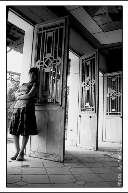 an image of a woman standing on the front porch
