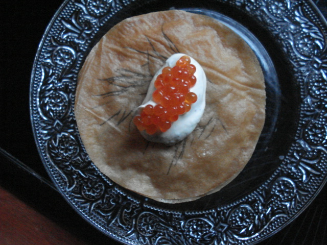 a plate with some red and white beads on top of it
