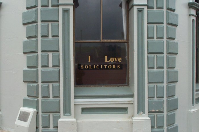 a close up of a building with a sign on the front window