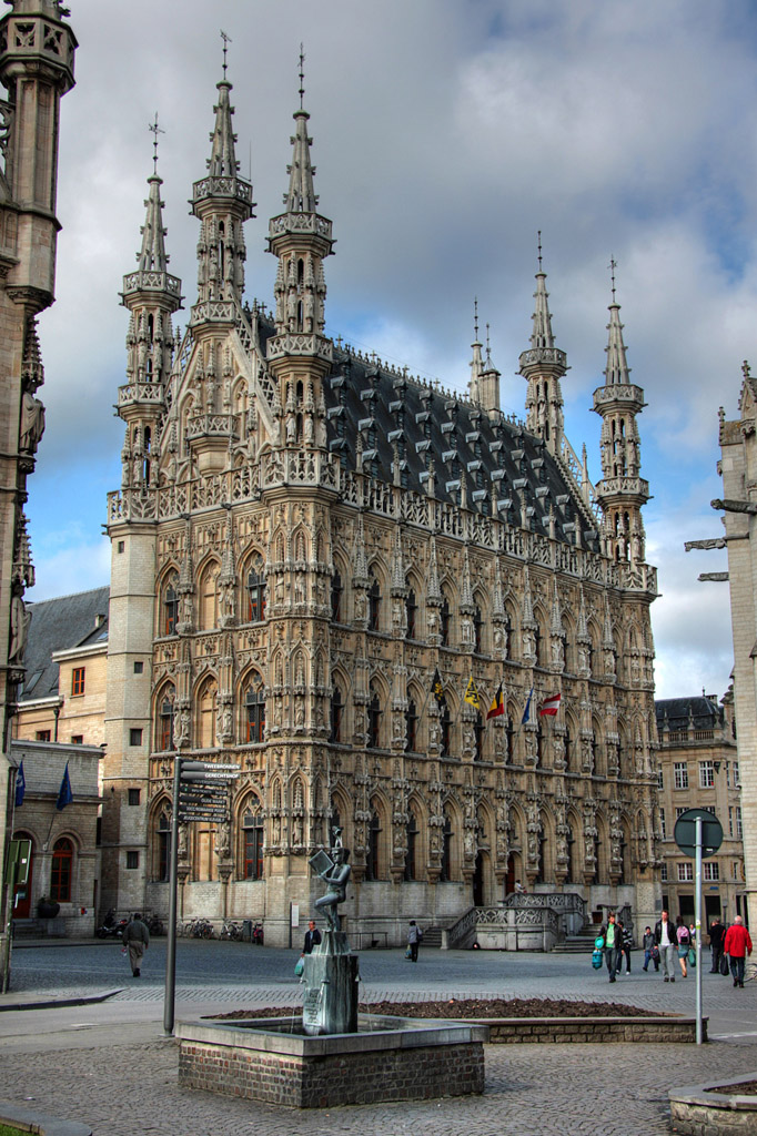 the front of a building with spires in a plaza