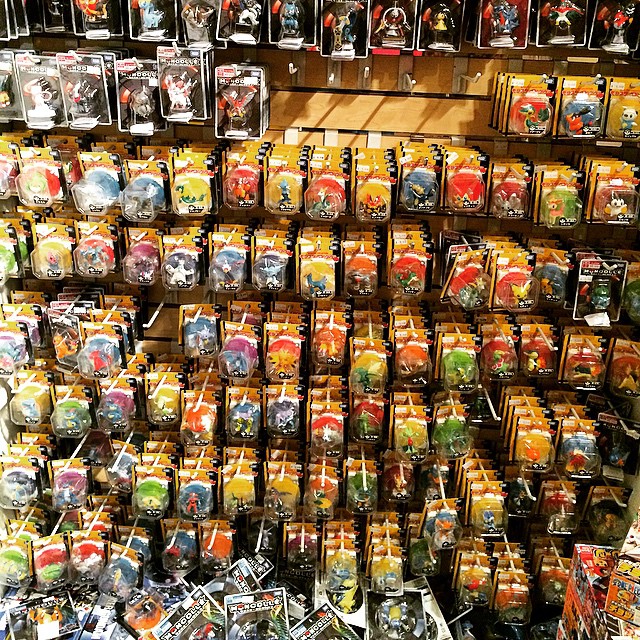 a store with assorted toy figures in baskets and bags