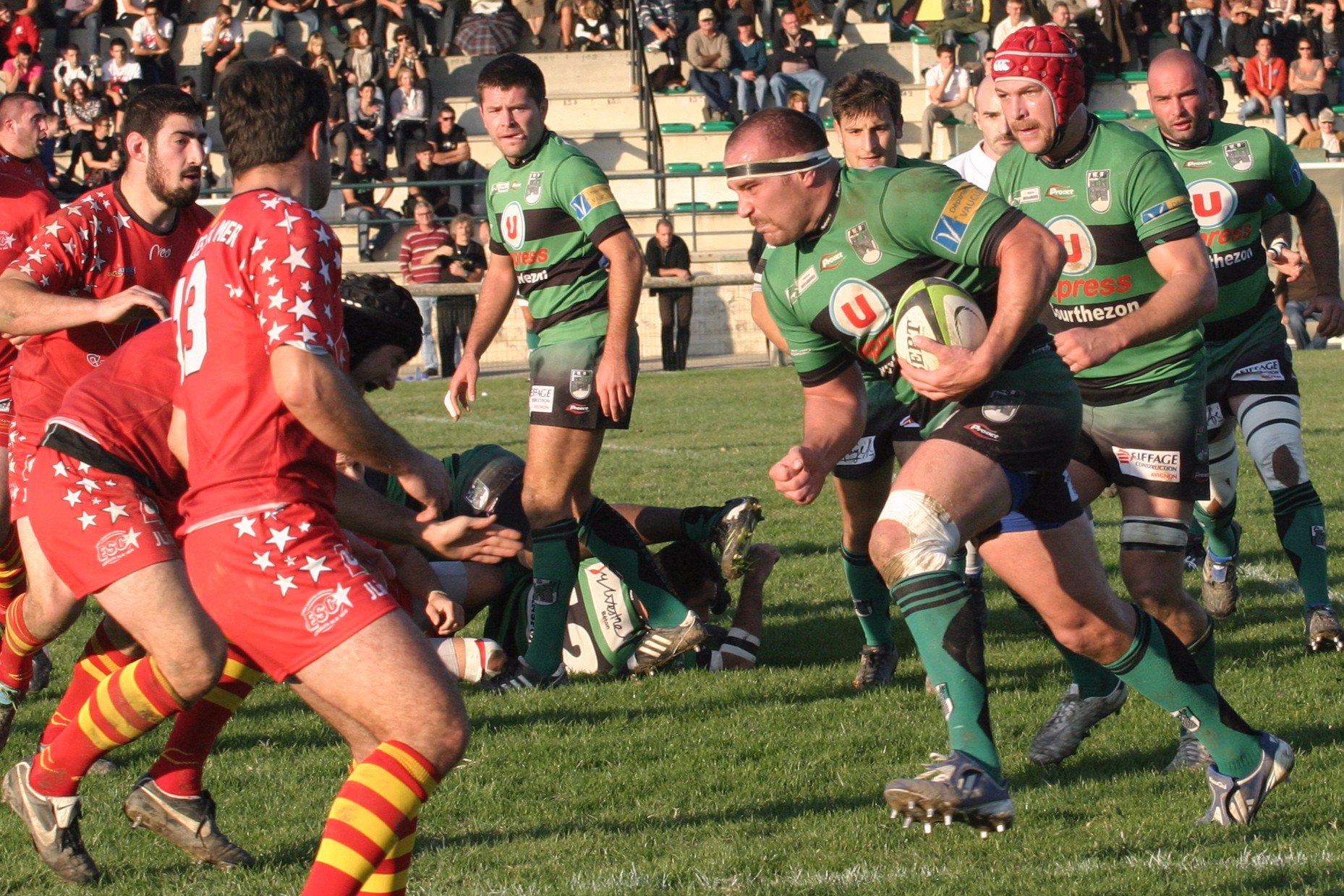 the men in red and green are playing rugby