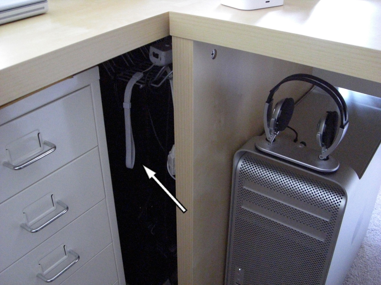 there is a small metal cabinet under a desk