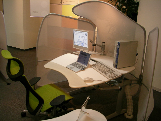 computer and laptop on desk in an office