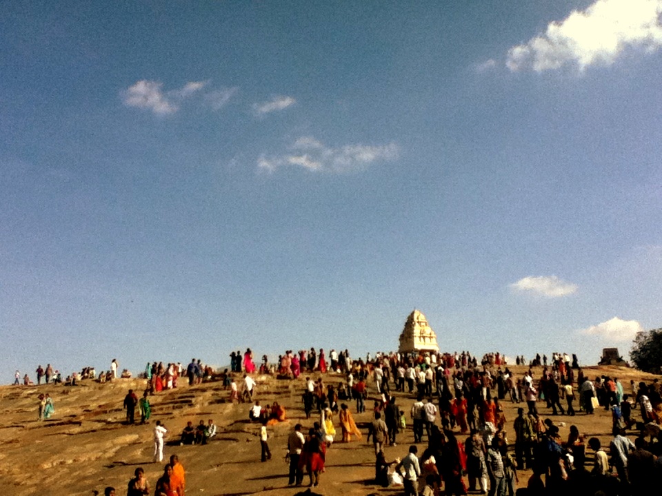 crowd of people at the top of hill with a large white dome