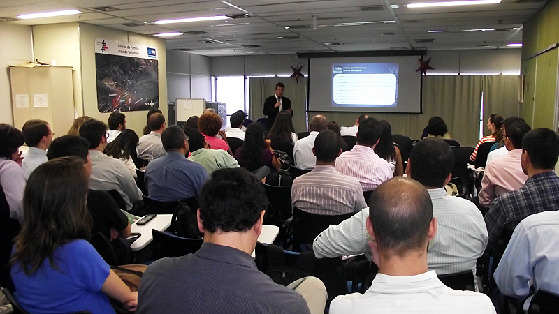 a man standing in front of a crowd watching a presentation