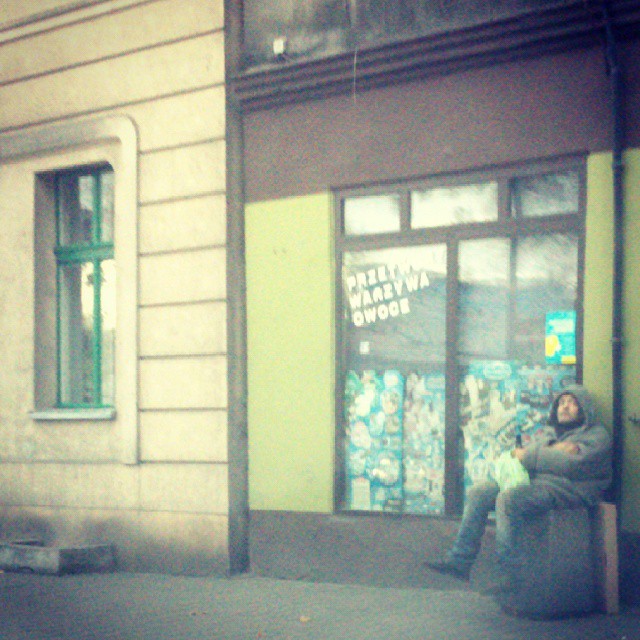 a woman on a bench next to a store