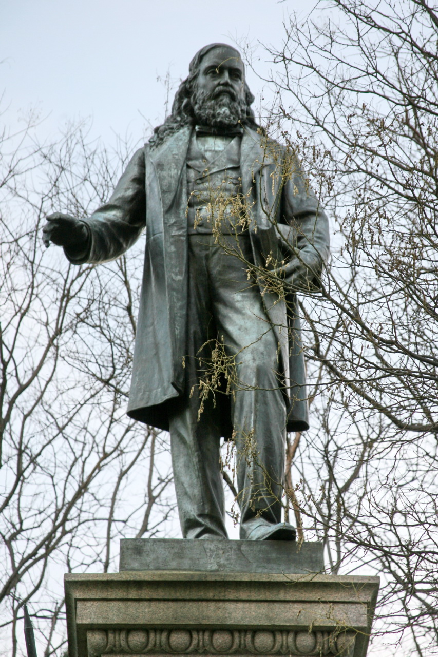 a statue that is standing in the grass