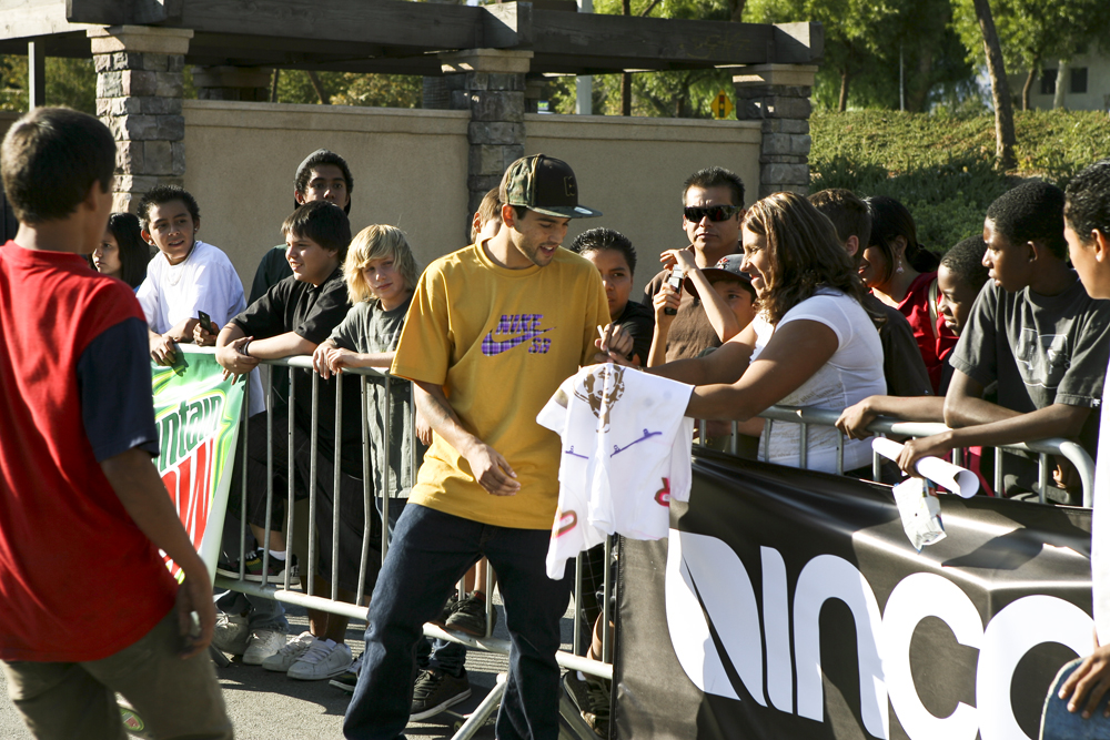 a man holding a sign next to a crowd of people