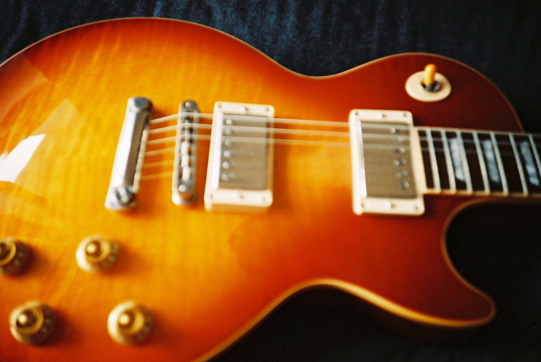 a close up of a brown electric guitar