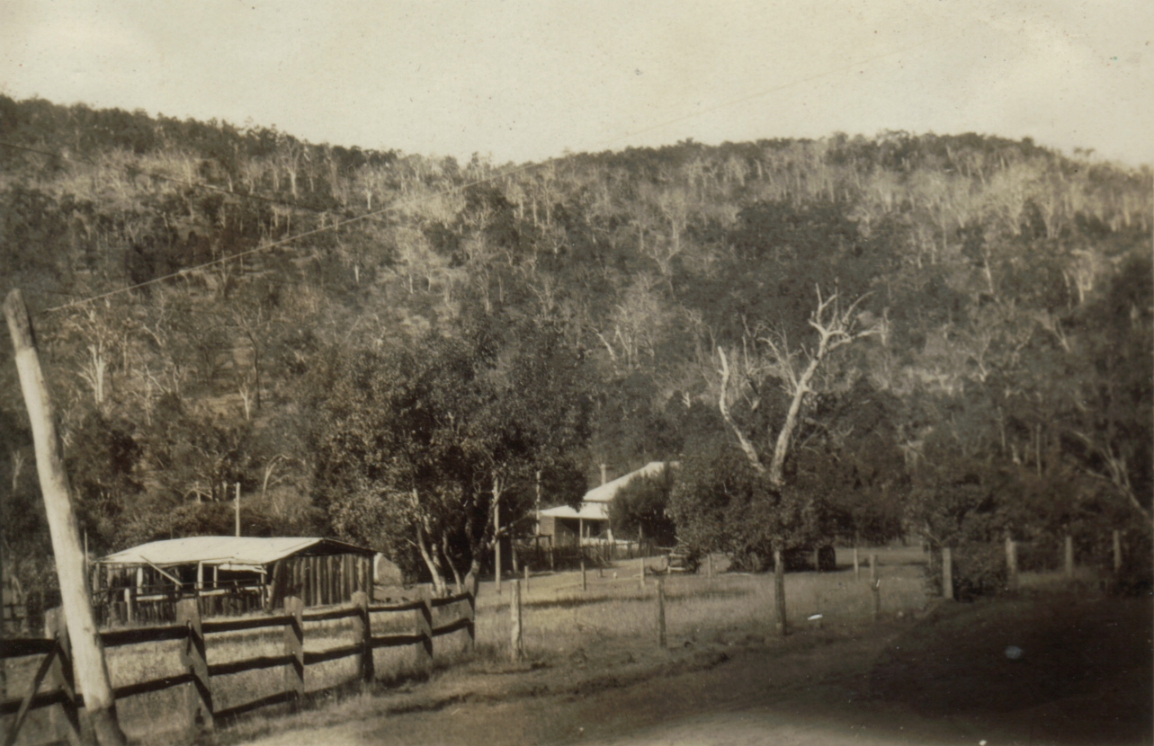 the image shows a rural area where buildings and farm equipment are displayed