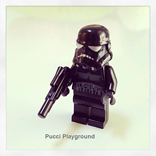 a lego figure is holding a gun on a white background