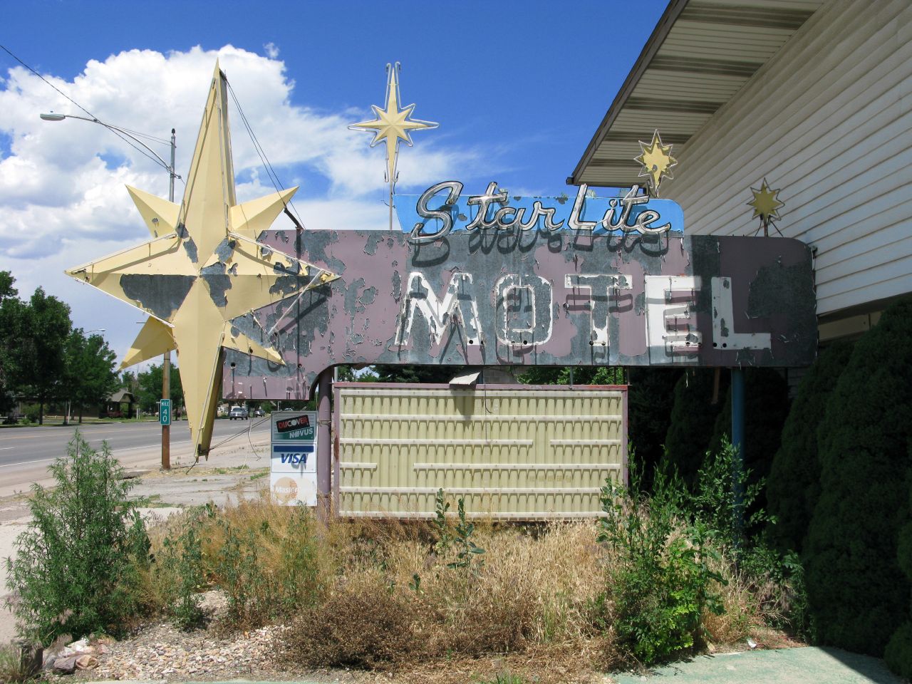 a faded sign is displayed on the side of the building