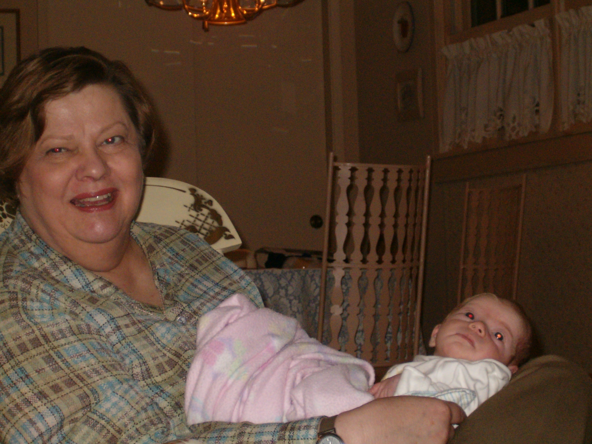 a woman holding her baby up to her chest