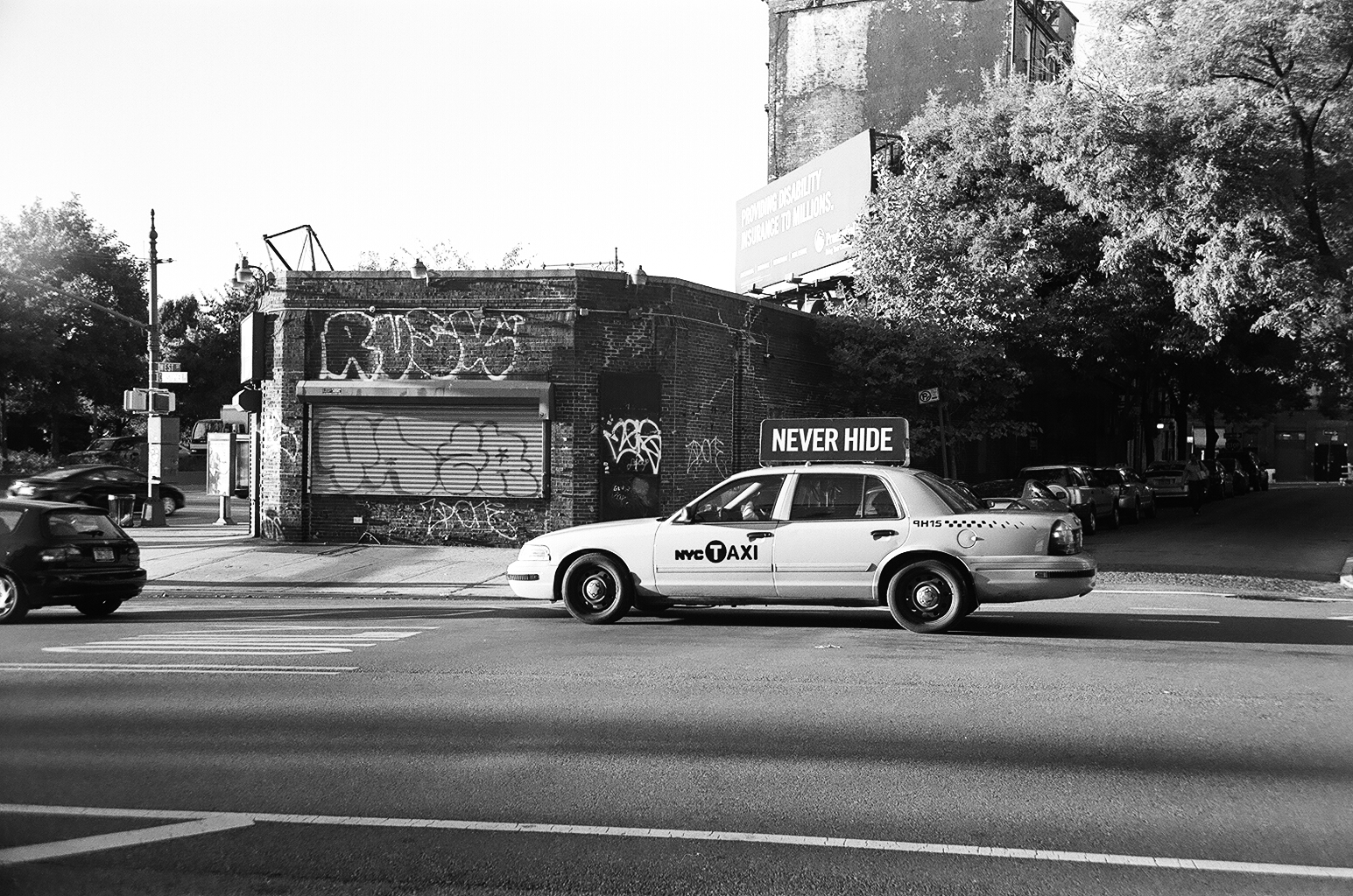 a taxi drives down the street at an intersection