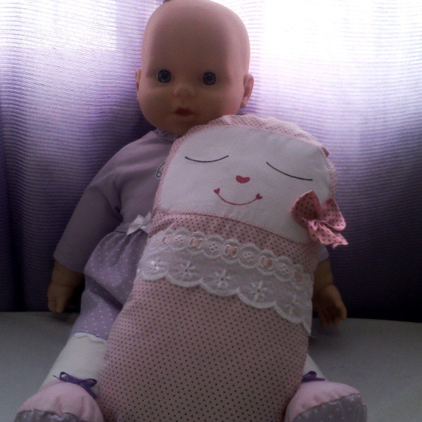 a baby doll is laying down on a table