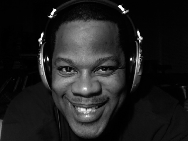 man with headphones on smiling and smiling