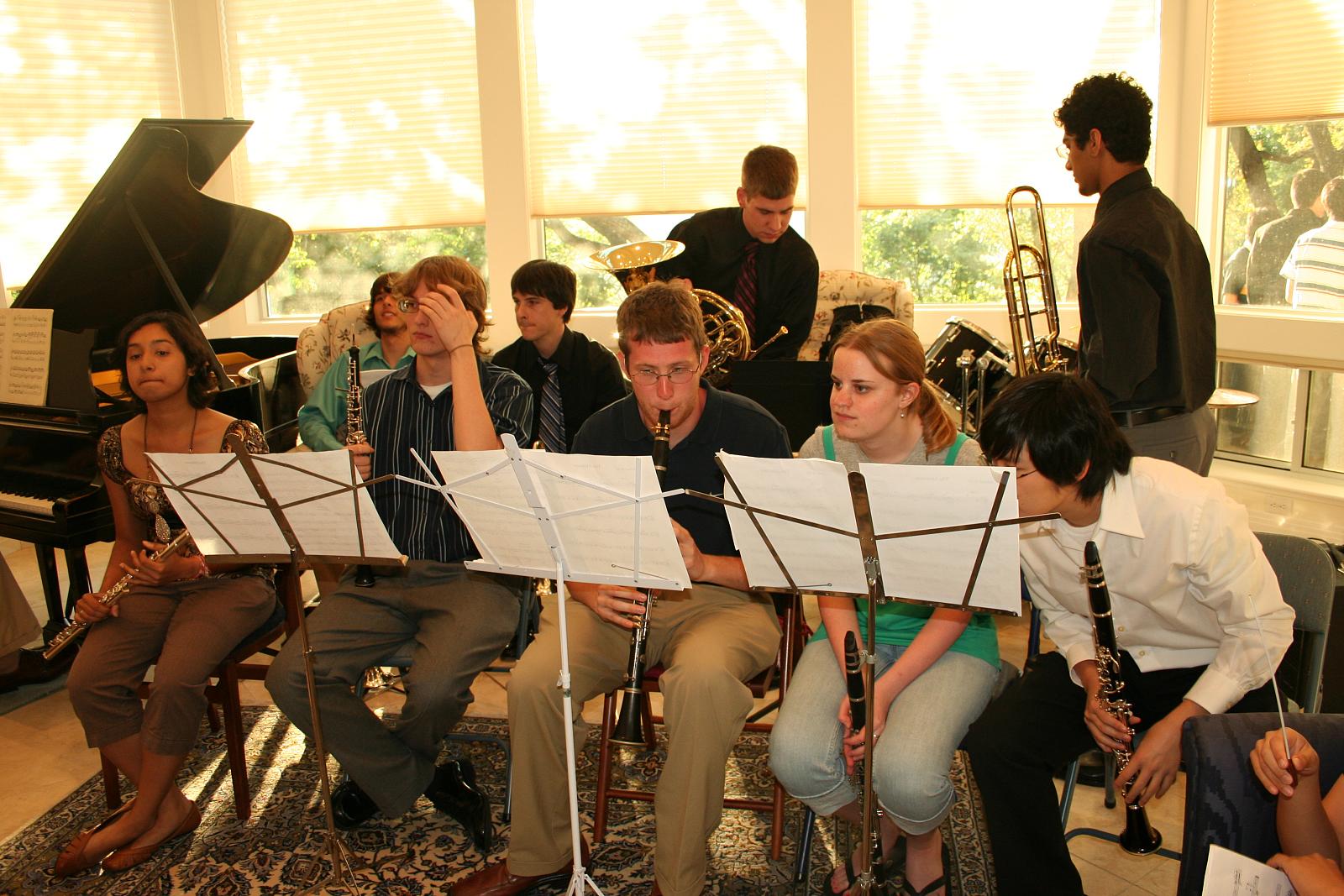 a group of people that are sitting around a musical instrument